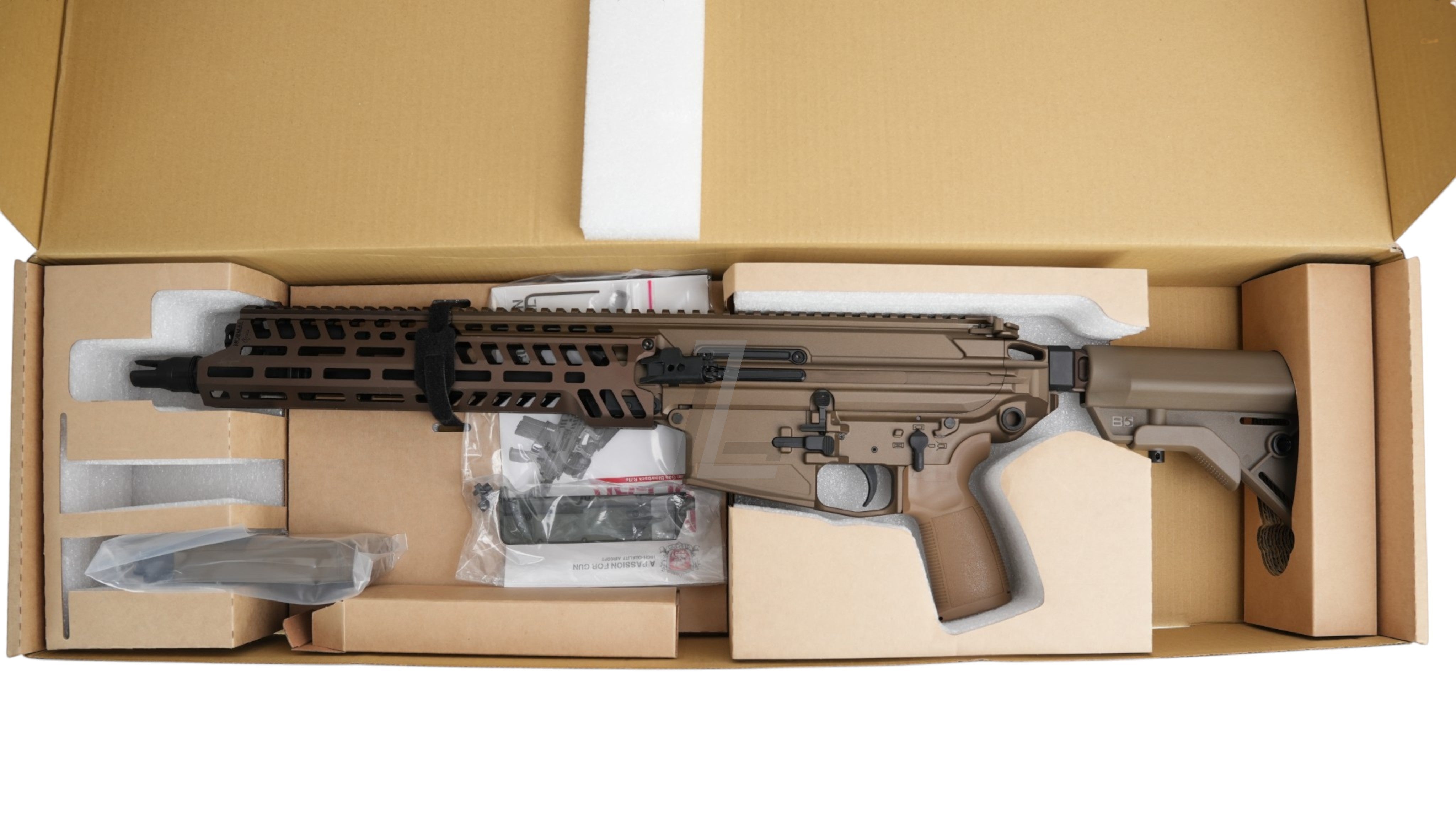 Landing Zone APFG XM7 GBB airsoft rifle in flat dark earth finish, displayed in its original cardboard packaging.