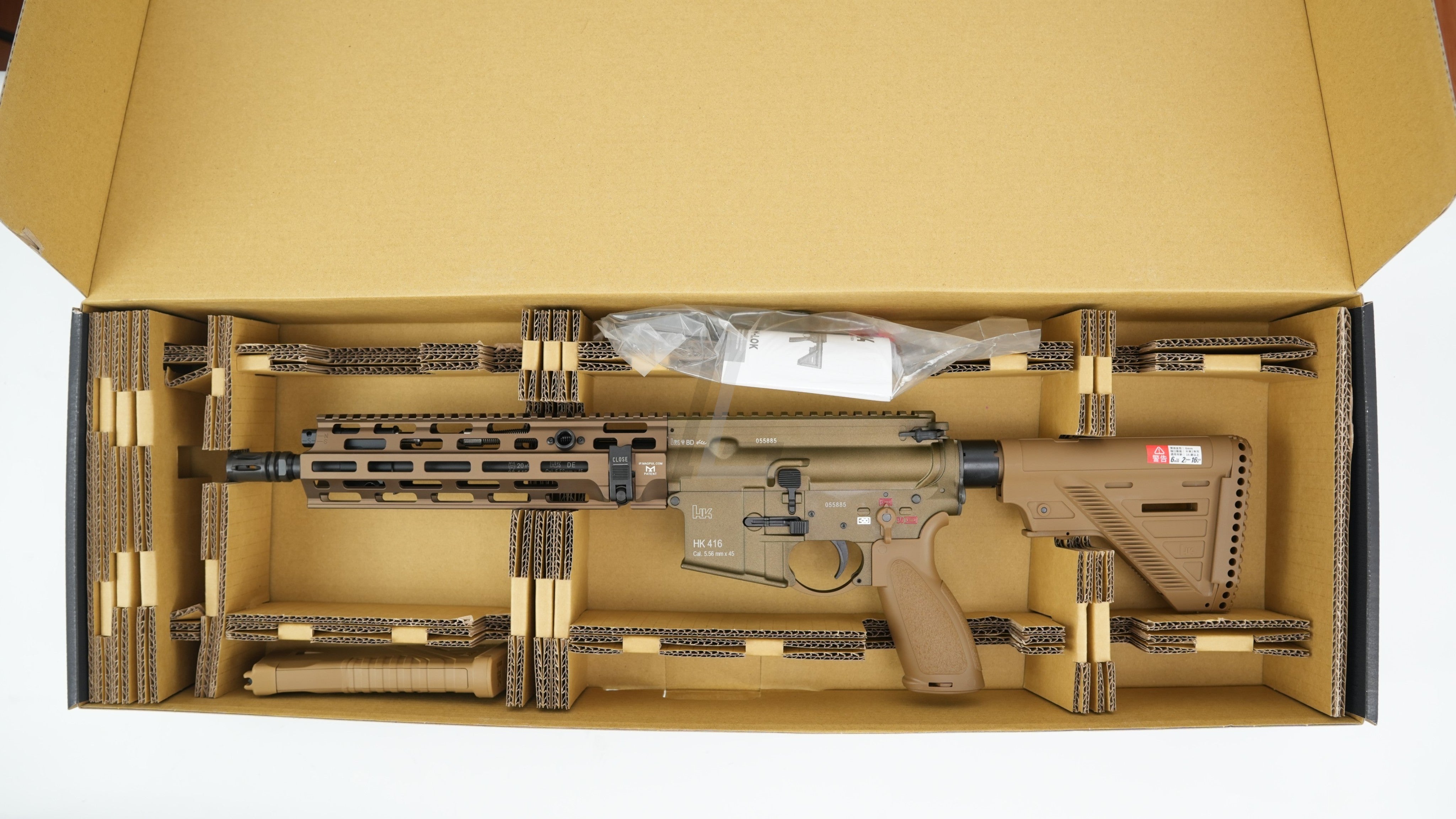 Landing Zone VFC Umarex HK416A5 M-LOK EVO GBB airsoft rifle in RAL8000 tan finish inside its cardboard packaging.